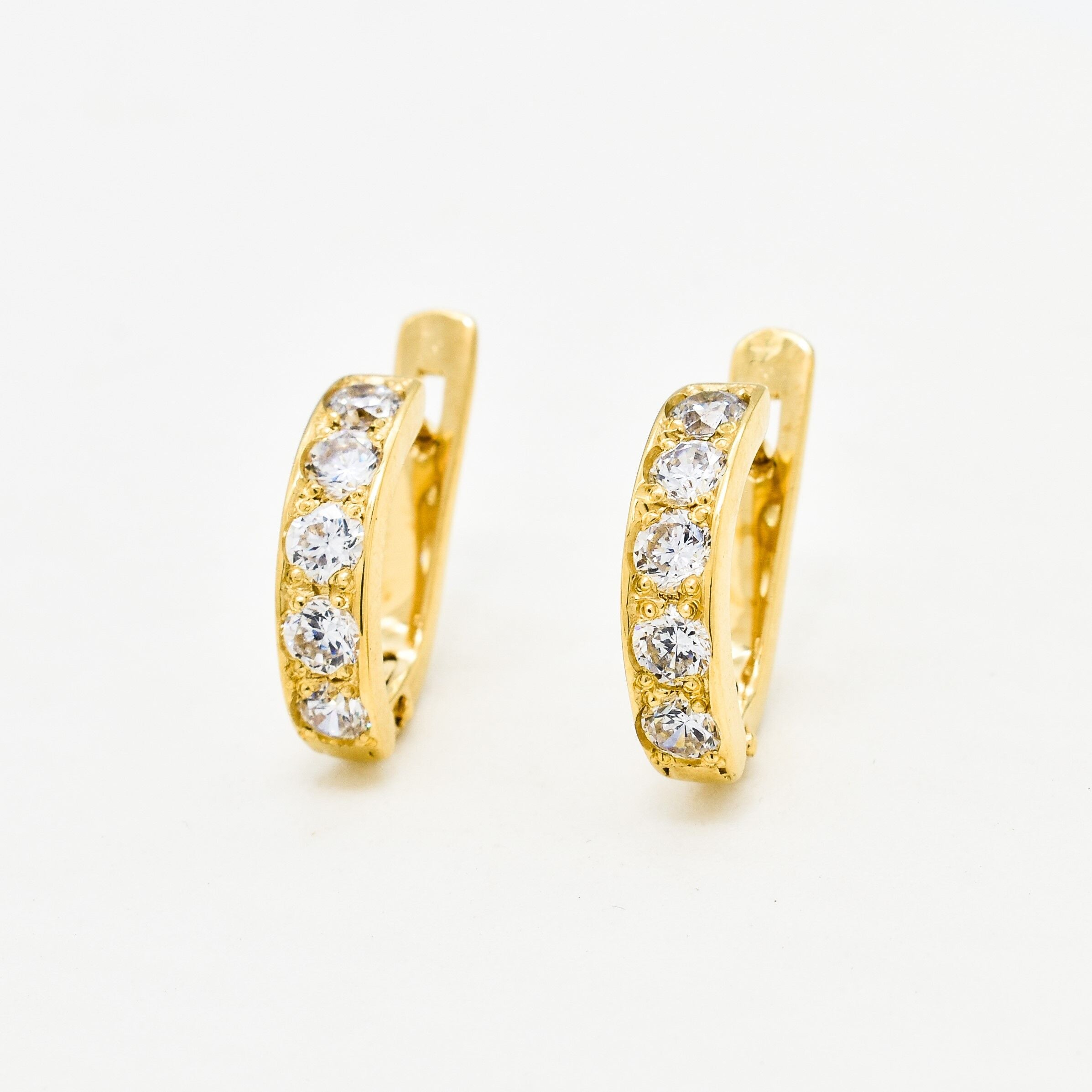 Yellow gold plated earrings with Diamond April birthstone in round cut and prong setting. Huggie earrings ideal for special occasions and personalized gift. Diamond - Symbol of eternal love, purity, and inner strength. For clarity, and abundance
