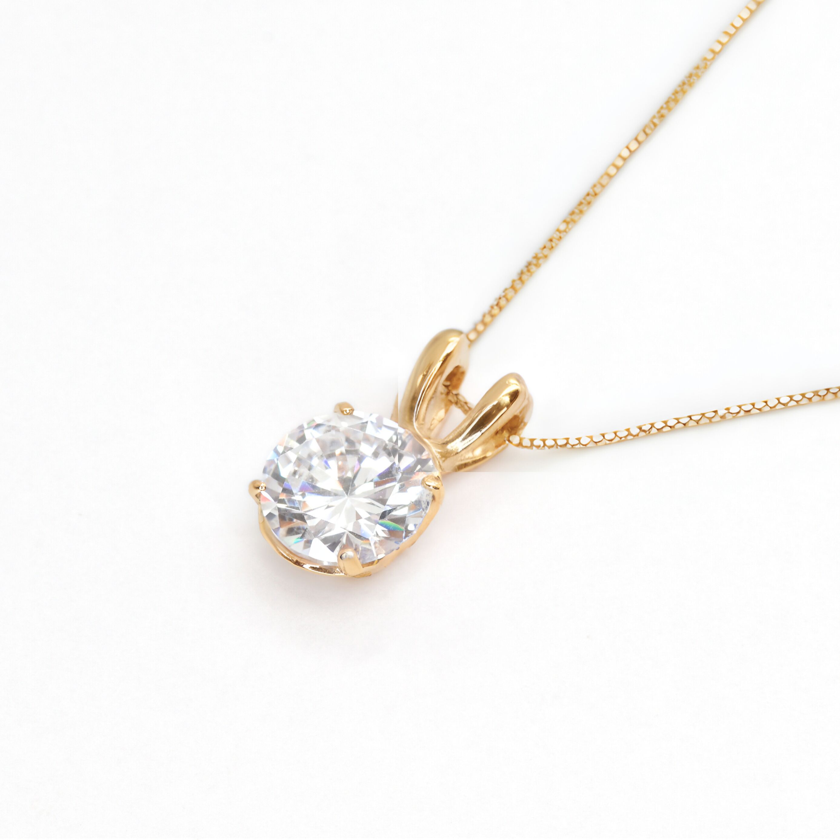 18k Yellow gold plated pendant with Diamond April birthstone in diamond and prong setting. Solitaire necklace ideal for special occasions and anniversary present. Round diamond necklace symbolizing eternal love, purity, and inner strength. 