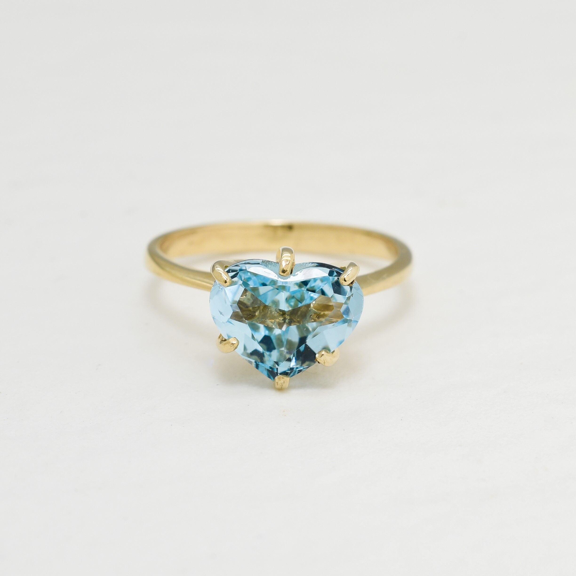 Heart Aquamarine March birthstone ring crafted in 18k Yellow Gold over Solid 925 Sterling Silver. Blue gemstone ring perfect as a valentine's gift idea, can be worn as an everyday ring that brings tranquility, aids in self-expression, and protects travelers. For courage, communication, soothing
