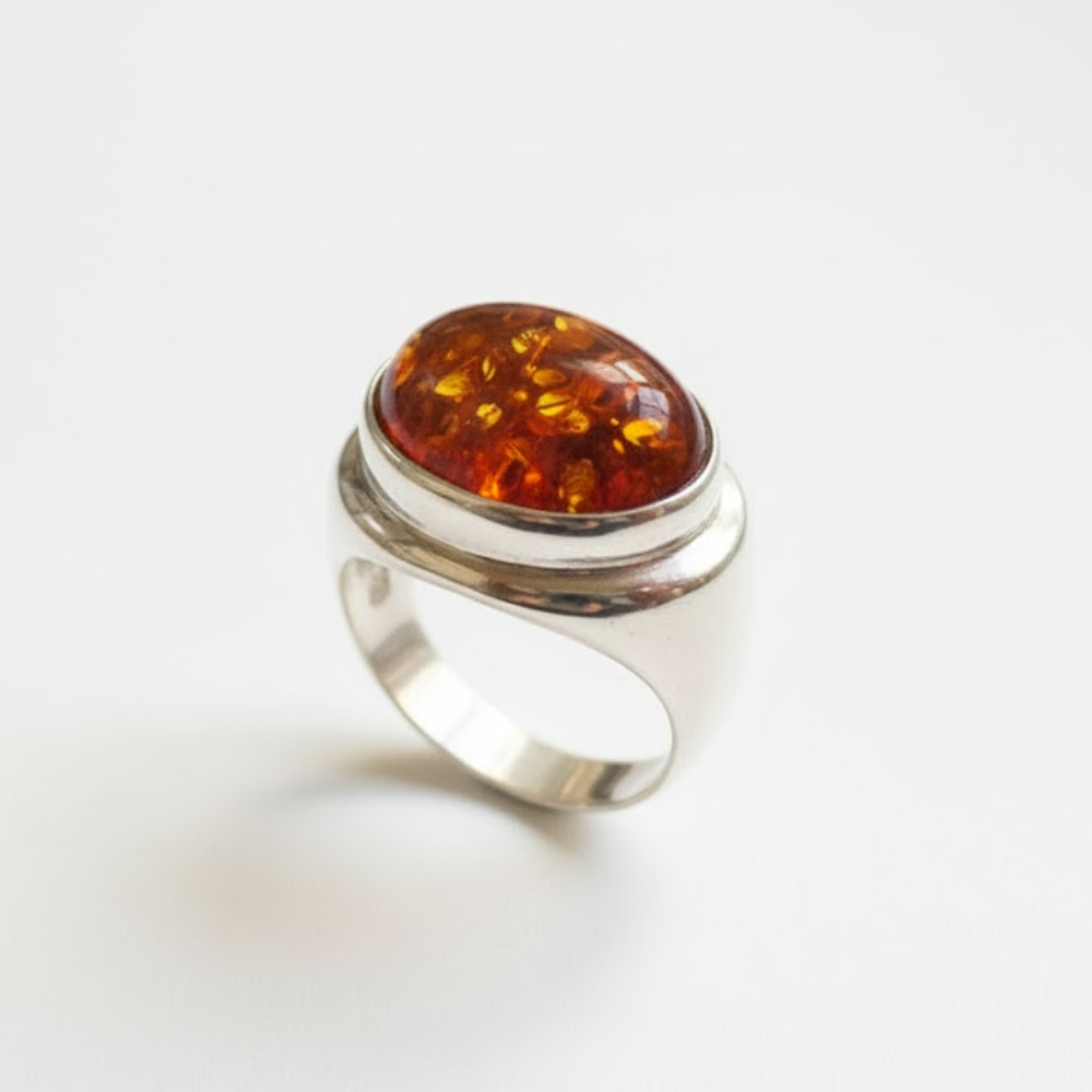 A vibrant sunset over a serene lake, with trees silhouetted against the colorful sky.