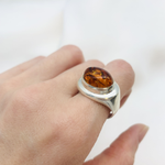 A stunning beach scene at dawn, with soft waves lapping against sandy shores and glowing pastel skies.