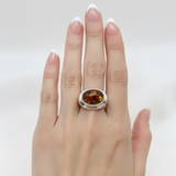 A close-up of a delicate flower blooming in a lush garden, showcasing intricate petals and vibrant colors.