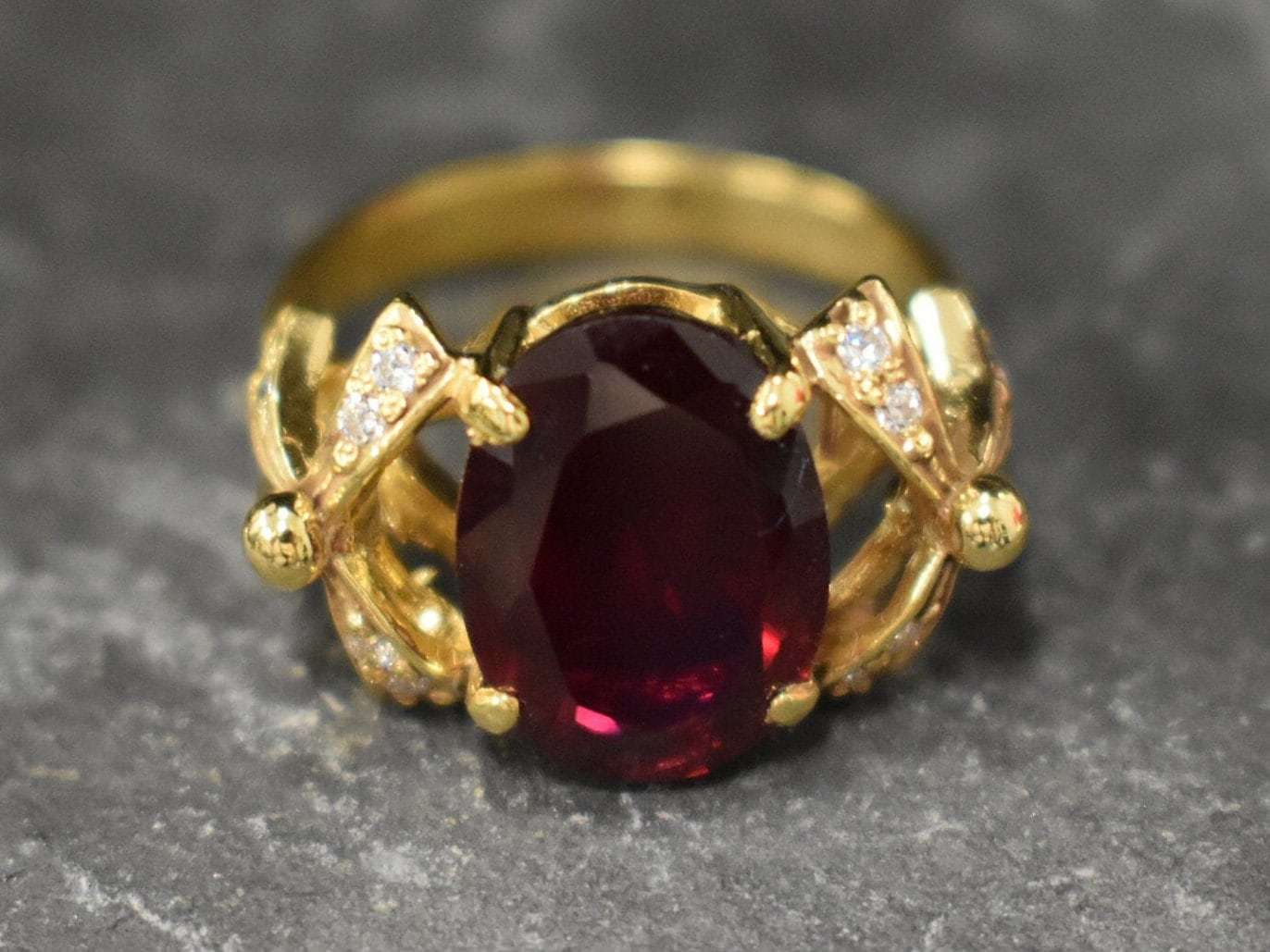 Exquisite 18k Gold Vermeil Ring showcasing an Oval Created Red Ruby, a perfect gift for July birthdays and elegant occasions.