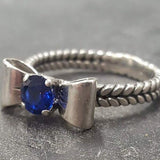 Stunning 925 Sterling Silver ring featuring a vibrant round created blue sapphire, perfect for celebrating September birthdays.