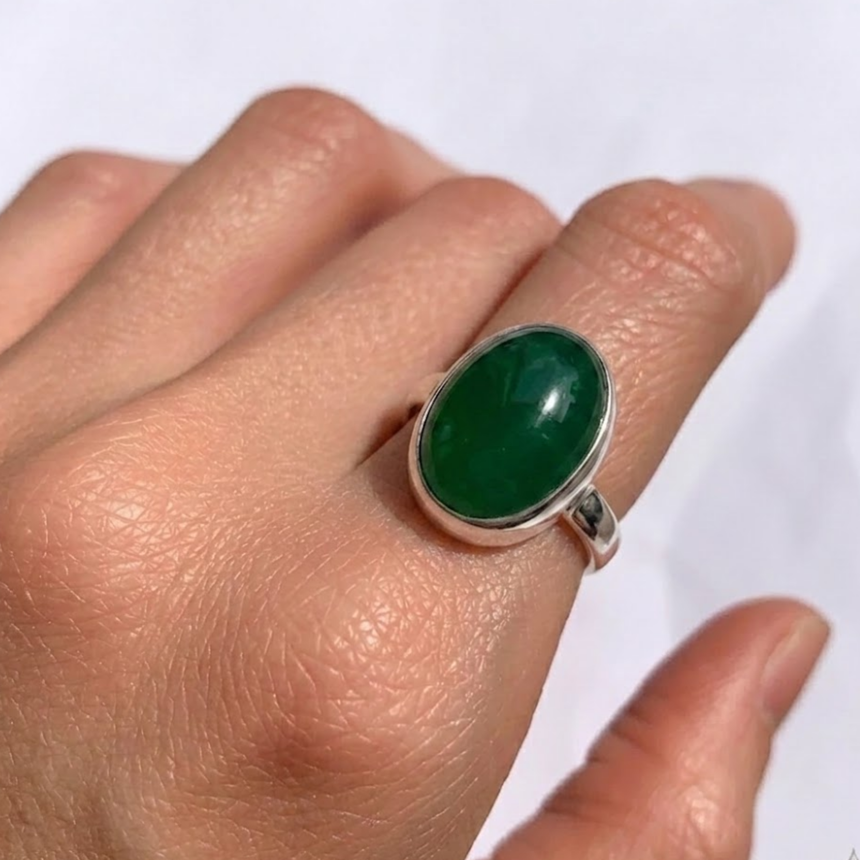 Elegant 925 Sterling Silver ring featuring a bezel-set oval Created Green Emerald, perfect for May birthdays and special occasions.