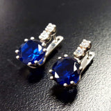 Stunning Created Sapphire Earrings crafted in 925 Sterling Silver, featuring round blue sapphires—symbolizing faithfulness and elegance.