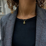 Radiant 18k Gold Vermeil Pendant featuring a vibrant round emerald, a meaningful May birthstone for nurturing and connection.