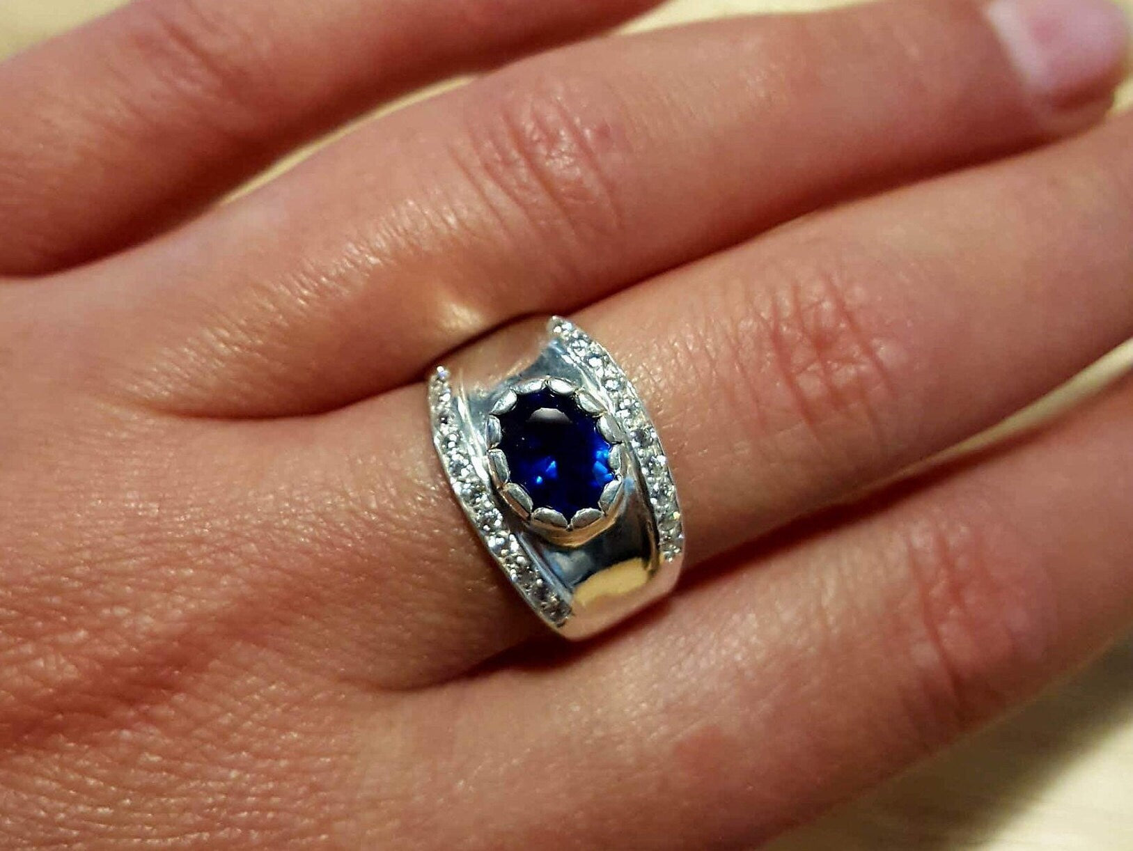 Elegant 925 Sterling Silver ring featuring a stunning Oval Created Blue Sapphire, perfect for September birthdays and special occasions.