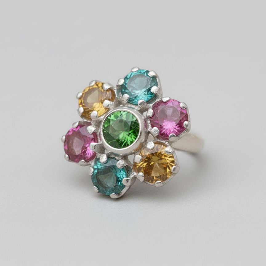 A beautiful gemstone ring displayed on a rustic wooden surface, showcasing its intricate design and sparkling finish.