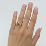 A beautifully arranged bouquet of vibrant flowers in a glass vase against a soft, neutral background.