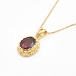 Stunning 18k gold vermeil ruby pendant featuring a striking oval created ruby, ideal for July birthdays and special moments.