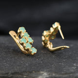 18k Gold Vermeil Earrings with natural green emeralds, perfect for those seeking beauty and emotional healing in their jewelry.