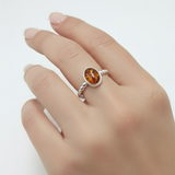 A stylish woman wearing layered bracelets, showcasing a mix of textures and colors that enhance her chic outfit.