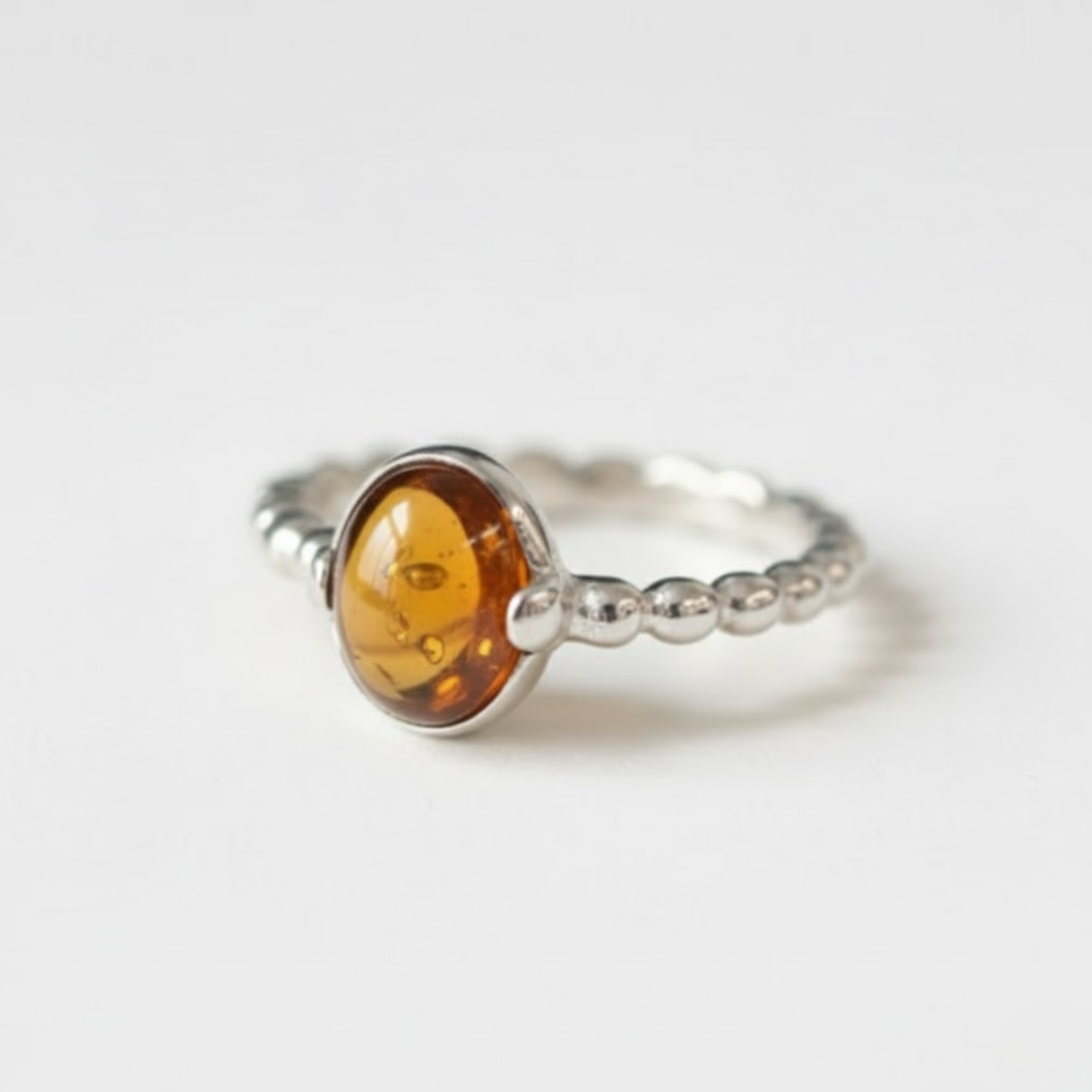 A serene landscape featuring a tranquil lake surrounded by lush green trees, reflecting the calm sky above.