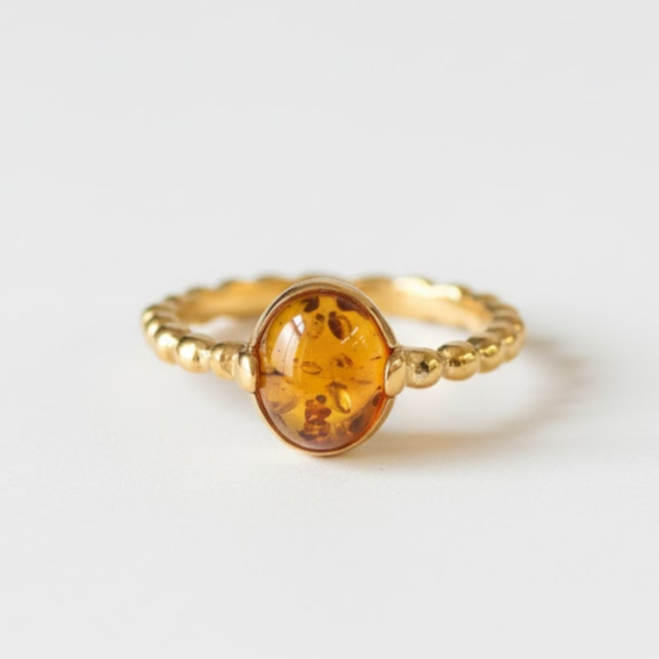 A cozy living room with a modern couch, colorful pillows, and a warm fireplace, creating a welcoming atmosphere.