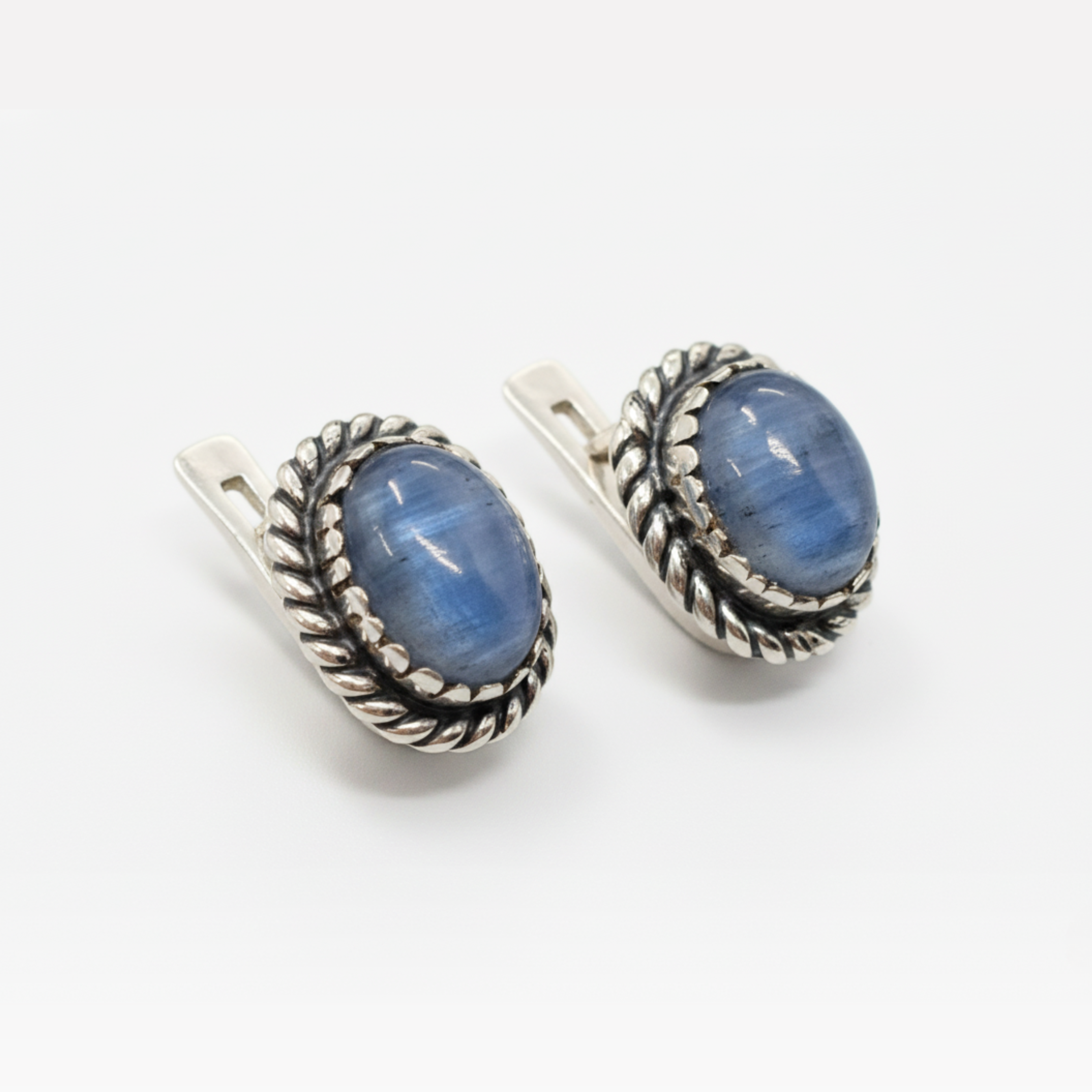 Stylish silver stud earrings witoval blue kyanite gemstones and intricate rope detailing.