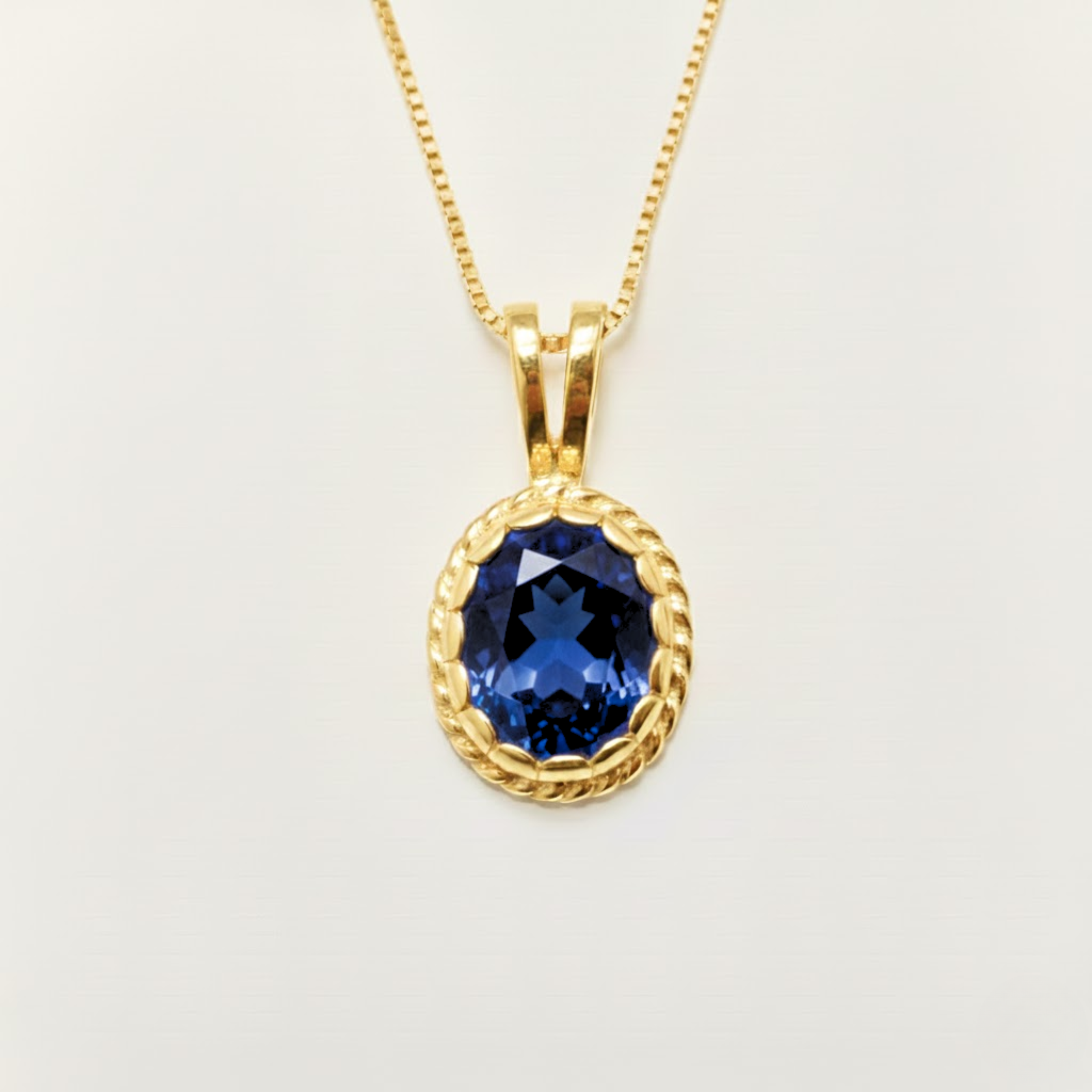 Elegant 18k Gold Vermeil Sapphire Pendant featuring a stunning oval created blue sapphire, perfect for special occasions.