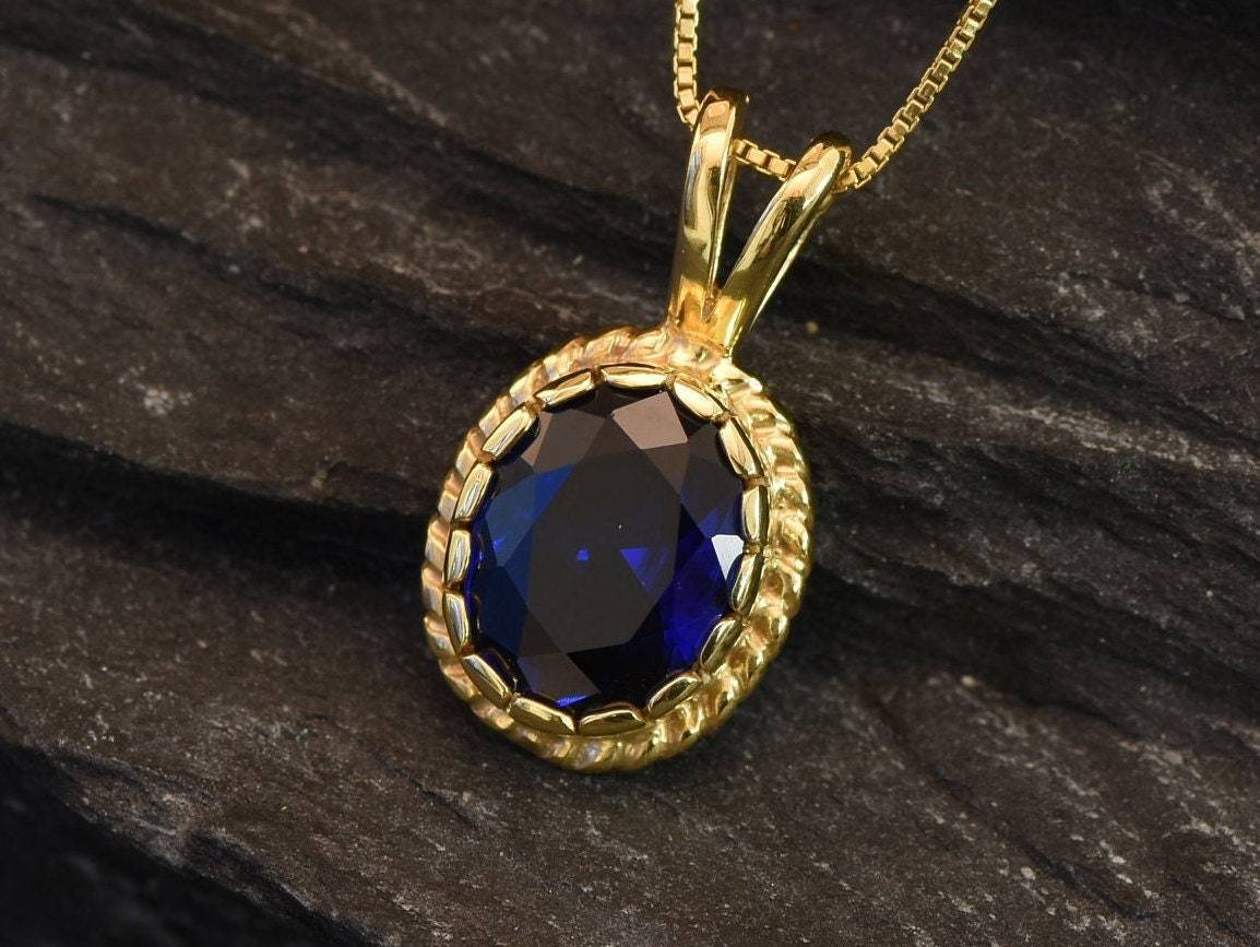 Elegant 18k Gold Vermeil Sapphire Pendant featuring a stunning oval created blue sapphire, perfect for special occasions.