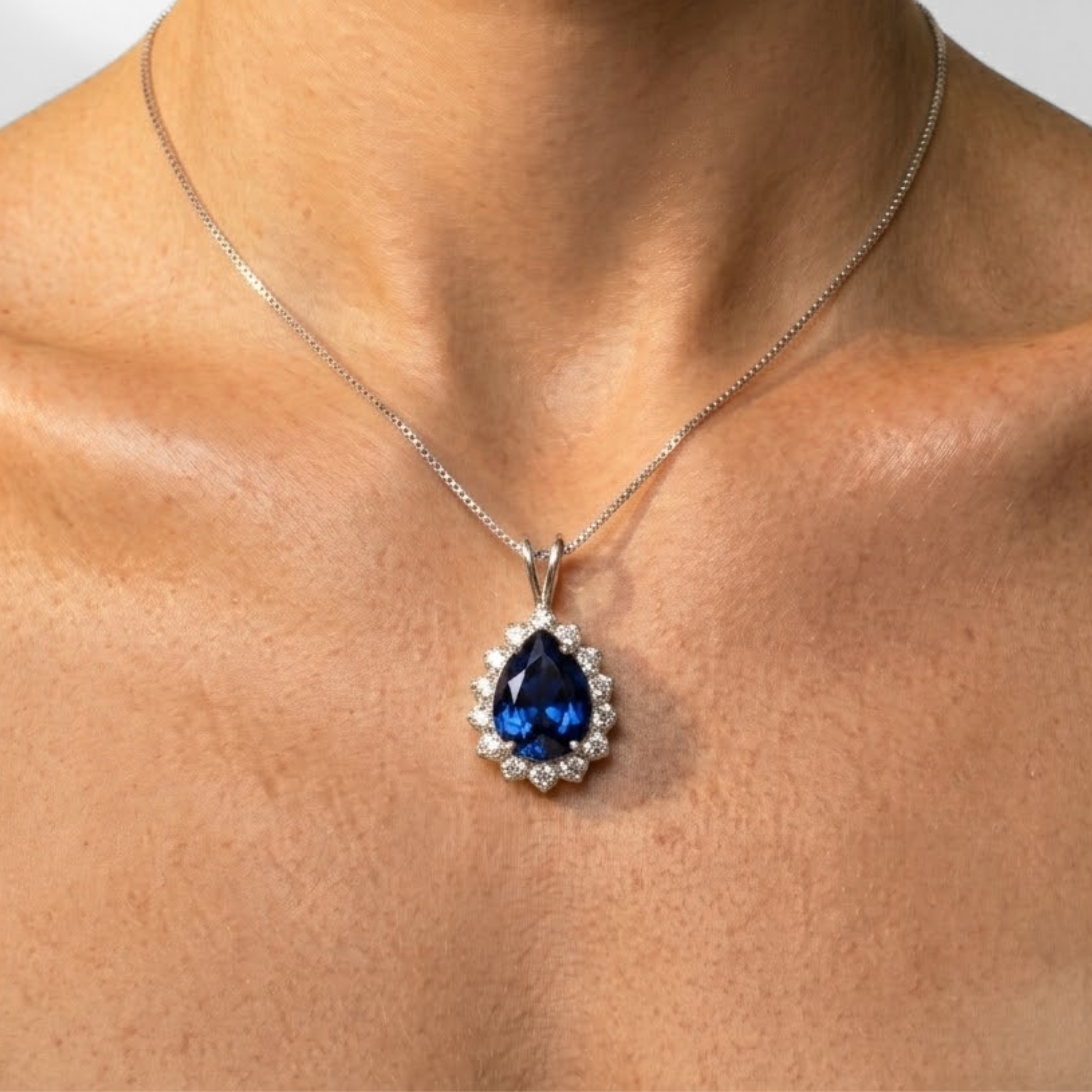 Elegant sapphire pendant in 925 sterling silver, prong-set with a pear-shaped blue sapphire, perfect for birthdays and special occasions.