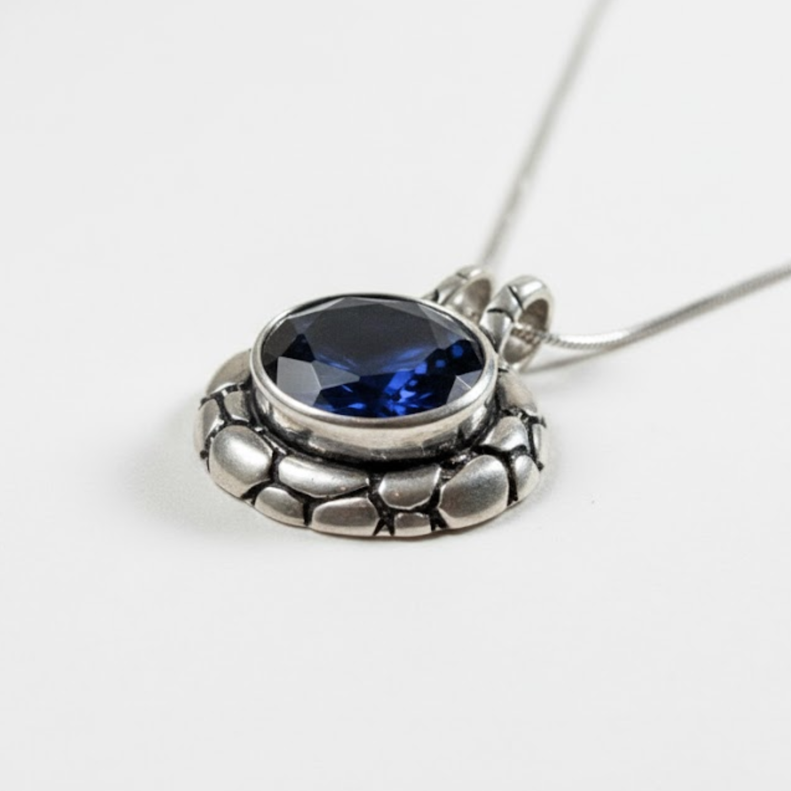 Sapphire pendant crafted from 925 sterling silver, showcasing a blue sapphire, a thoughtful gift for September birthdays.