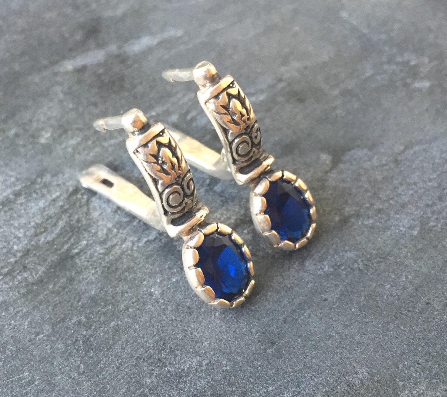 Created Sapphire Earrings made in 925 Sterling Silver with Oval Created Blue Sapphire in Prong setting, September Birthstone gift idea, symbolizes sincerity, truth, and faithfulness, ideal for everyday wear and perfect for birthday gifting and special occasions.