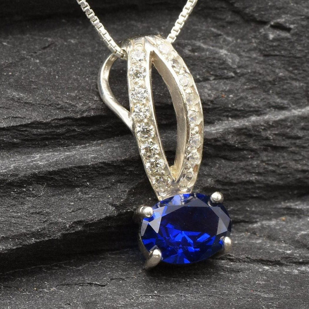 Charming 925 Sterling Silver pendant with oval blue sapphire, September birthstone, a perfect expression of loyalty and love.