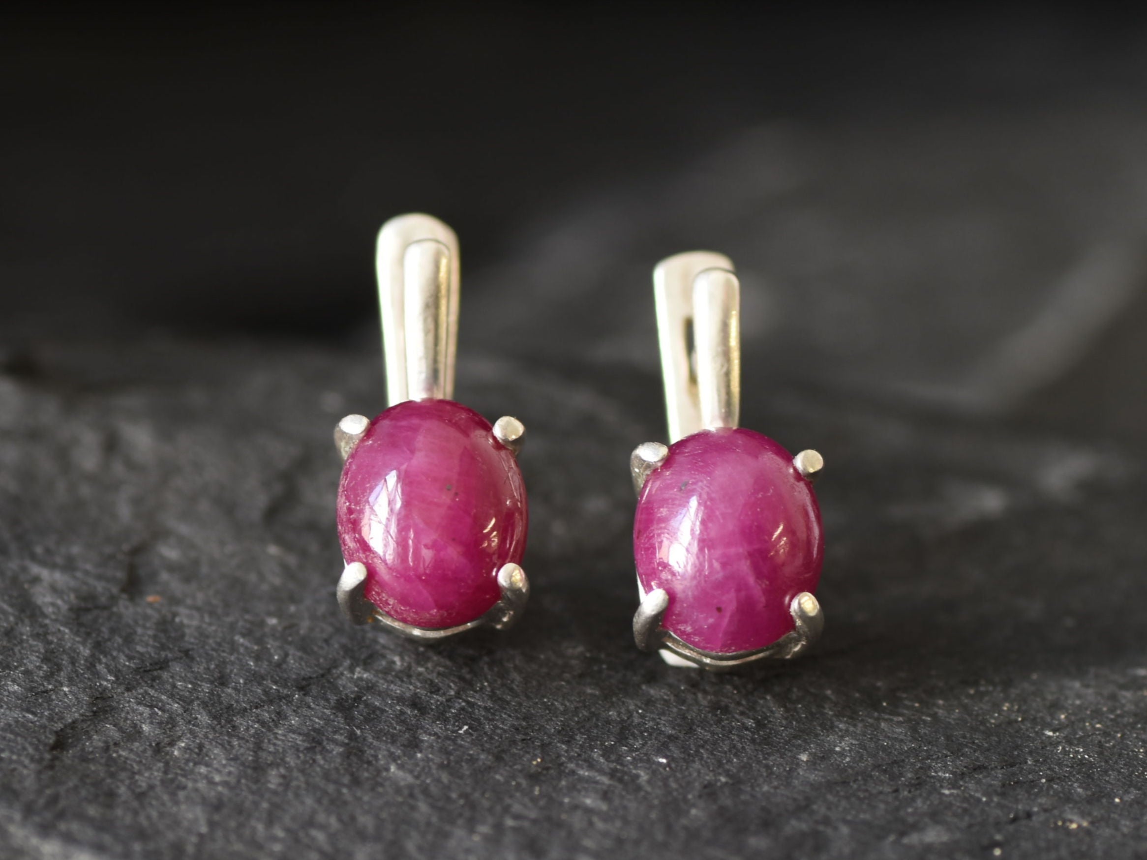 Ruby earrings in sterling silver, featuring prong-set natural red rubies, perfect for birthdays and special occasions.