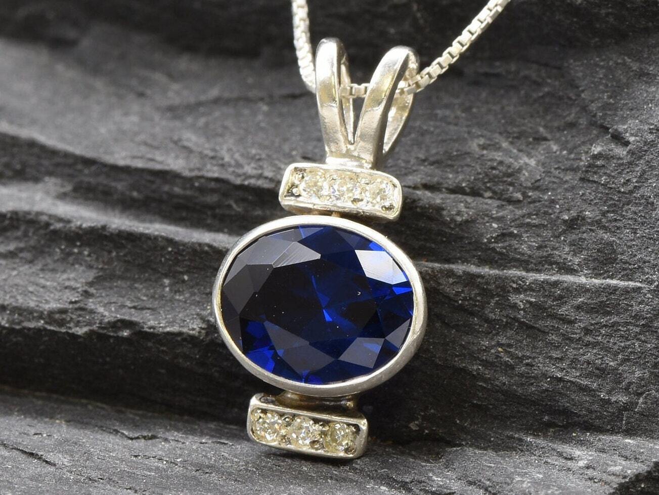 Created Sapphire Pendant made in 925 Sterling Silver with Oval Created Blue Sapphire in Bezel setting, September Birthstone gift idea, symbolizes sincerity, truth, and faithfulness, ideal for everyday wear and perfect for birthday gifting and special occasions.
