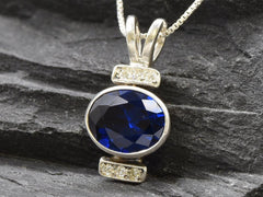 Created Sapphire Pendant made in 925 Sterling Silver with Oval Created Blue Sapphire in Bezel setting, September Birthstone gift idea, symbolizes sincerity, truth, and faithfulness, ideal for everyday wear and perfect for birthday gifting and special occasions.
