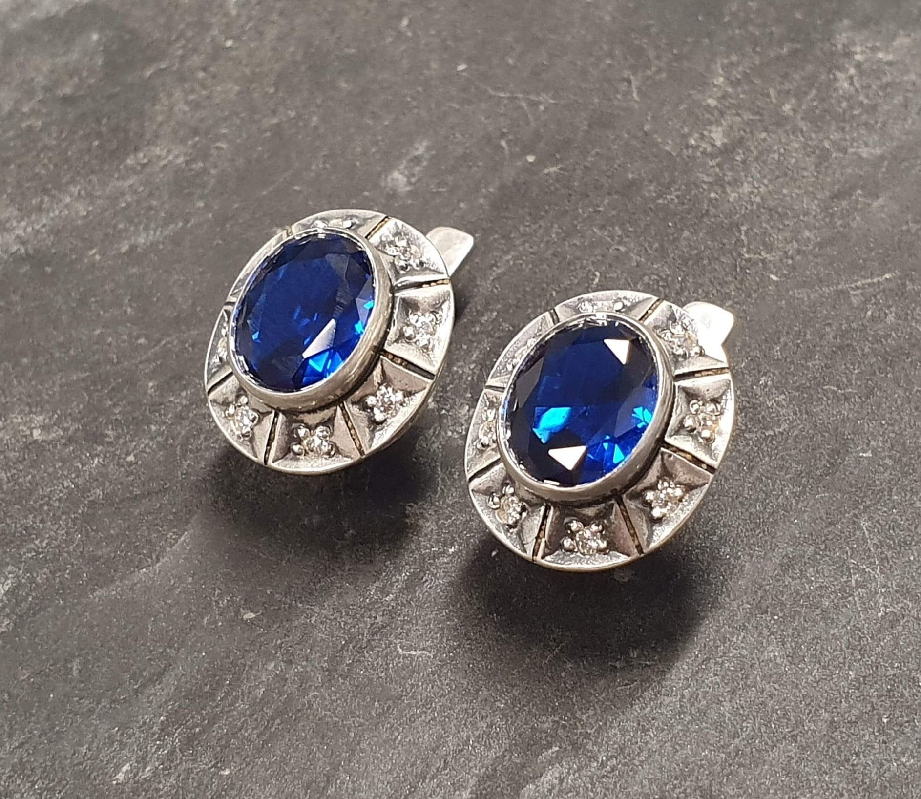 Created Sapphire Earrings made in 925 Sterling Silver with Oval Created Blue Sapphire in Bezel setting, September Birthstone gift idea, symbolizes sincerity, truth, and faithfulness, ideal for everyday wear and perfect for birthday gifting and special occasions.
