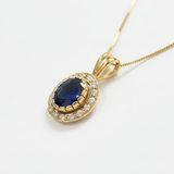 Stunning Halo-set Oval Created Blue Sapphire Pendant in 18k Gold Vermeil, a meaningful September birthday gift.