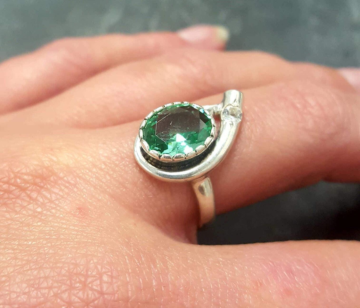 Sterling Silver Emerald Ring featuring a vibrant oval Created Green Emerald, perfect for May birthdays and special occasions.