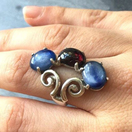 Elegant Sterling Silver Ruby Ring featuring a vibrant oval red ruby in a classic three-stone design, perfect for July birthdays.