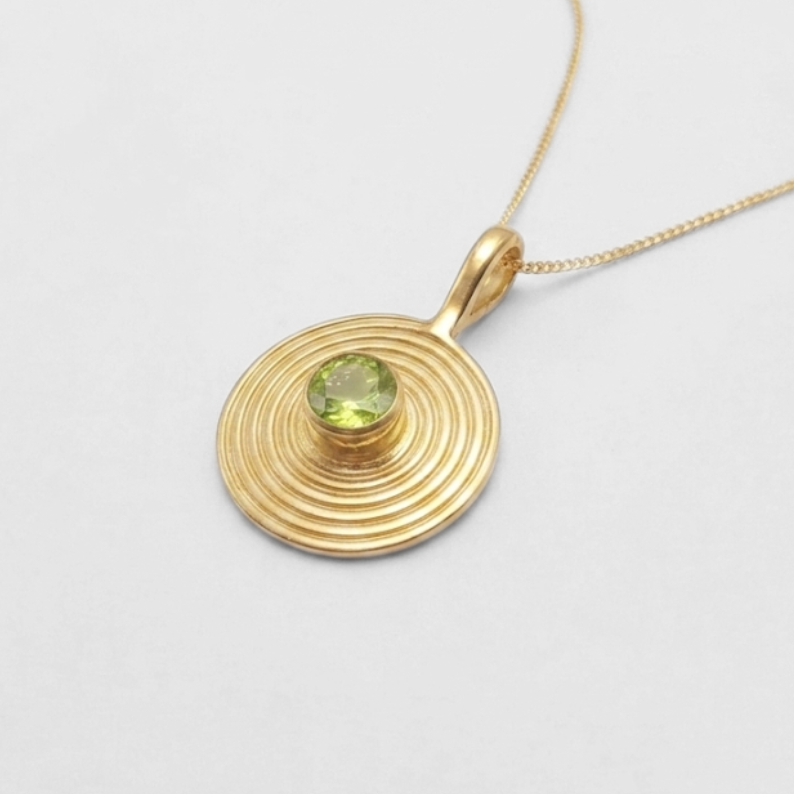 Peridot bezel pendant in 18k gold vermeil, green August birthstone symbolizing renewal—great for birthdays & everyday wear