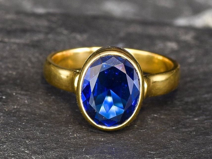 Created Sapphire Ring made in 18k Gold Vermeil with Oval Created Blue Sapphire in Bezel setting, September Birthstone gift idea, symbolizes sincerity, truth, and faithfulness, ideal for everyday wear and perfect for birthday gifting and special occasions.