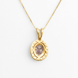 Elegant display of Adina Stone jewelry arranged on a reflective surface, highlighting their brilliance and craftsmanship.