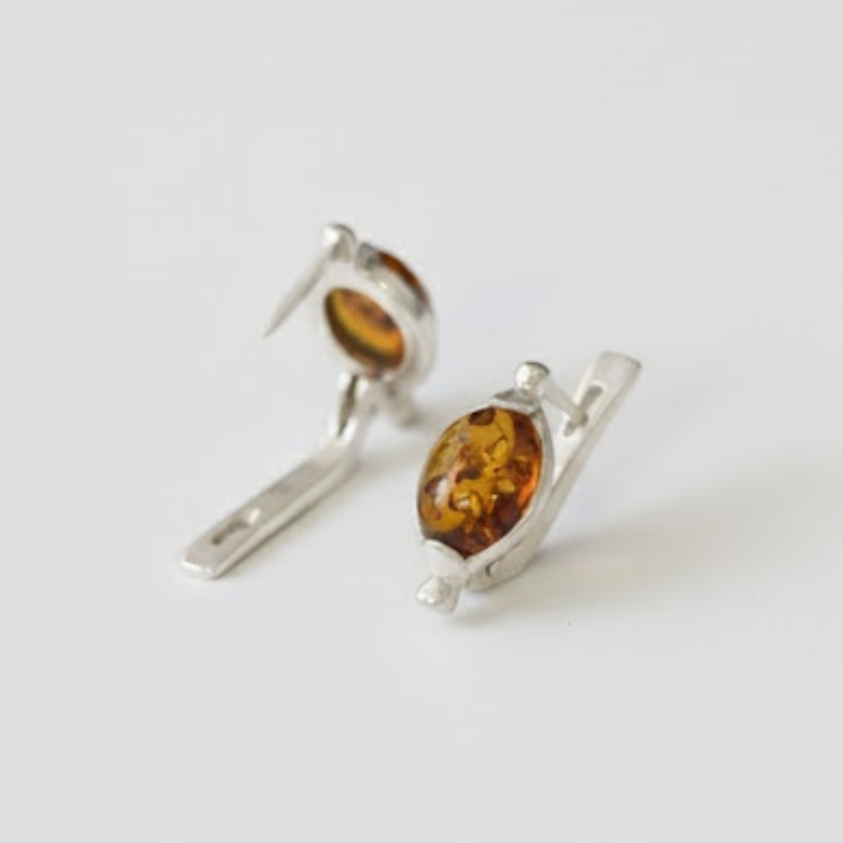 A cozy cabin nestled in a snowy forest, with smoke curling from the chimney against a backdrop of pine trees.