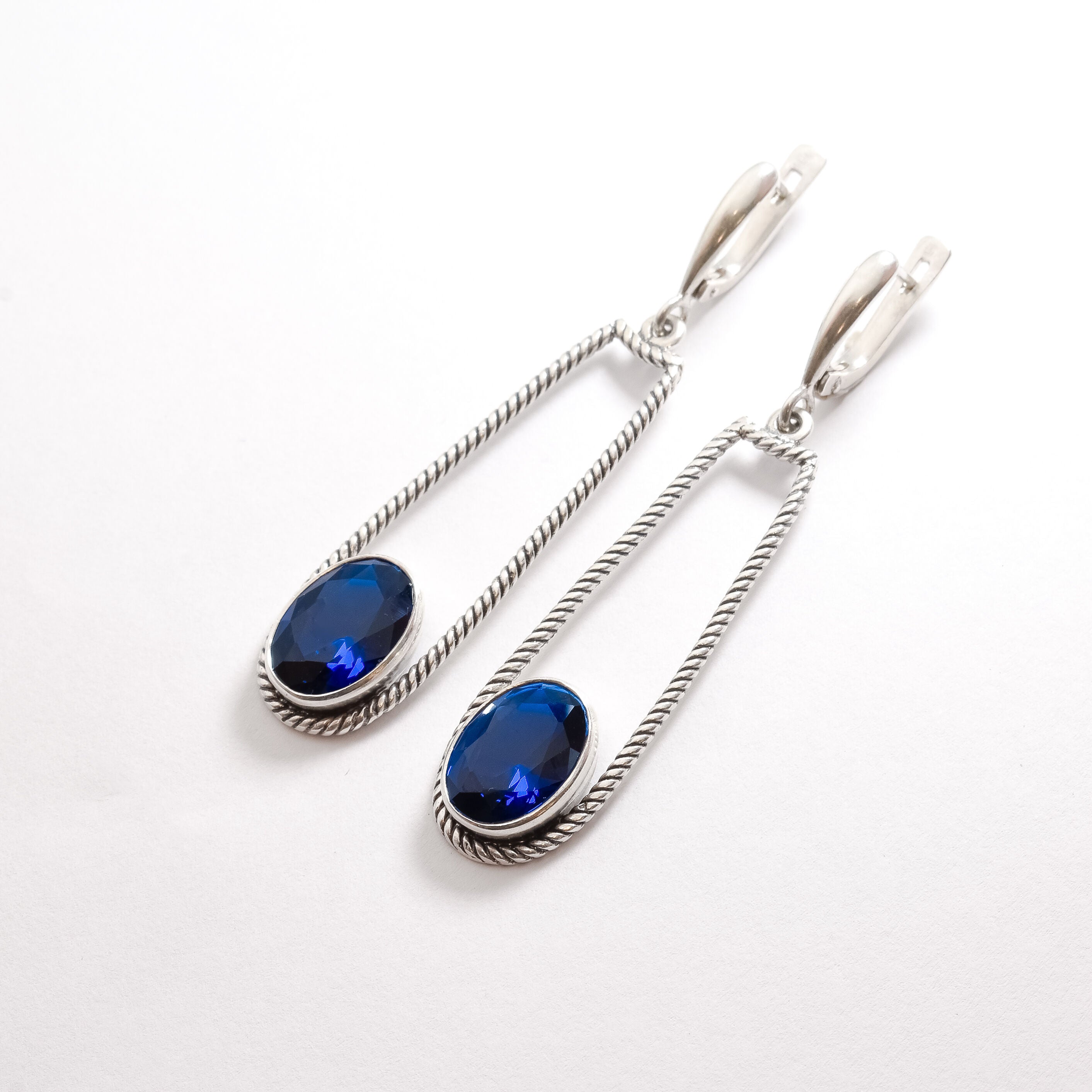 Created Sapphire Earrings made in 925 Sterling Silver with Oval Created Blue Sapphire in Bezel setting, September Birthstone gift idea, symbolizes sincerity, truth, and faithfulness, ideal for everyday wear and perfect for birthday gifting and special occasions.