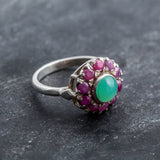 A scenic view of a sunset over a calm lake, reflecting vibrant hues of orange and purple in the water.