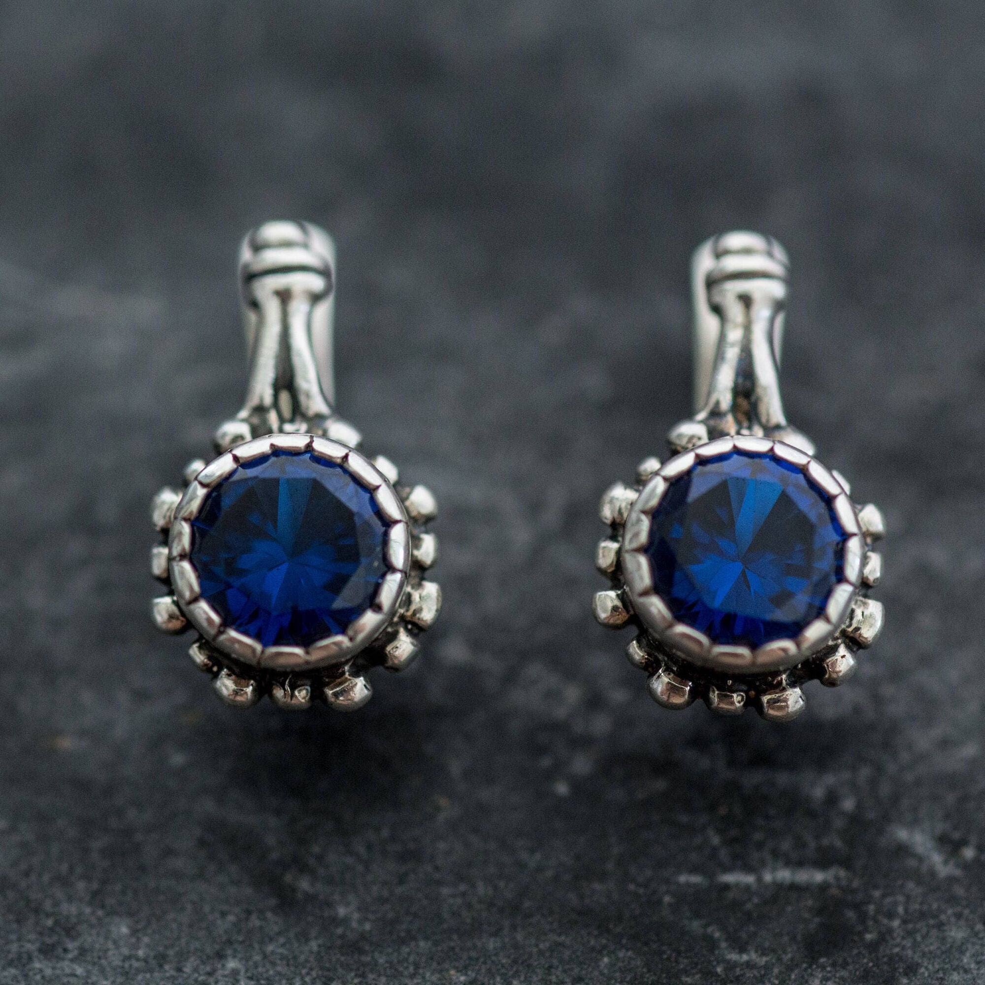 Dazzling 925 Sterling Silver Earrings adorned with Round Created Blue Sapphire, embodying faithfulness and elegance for any event.