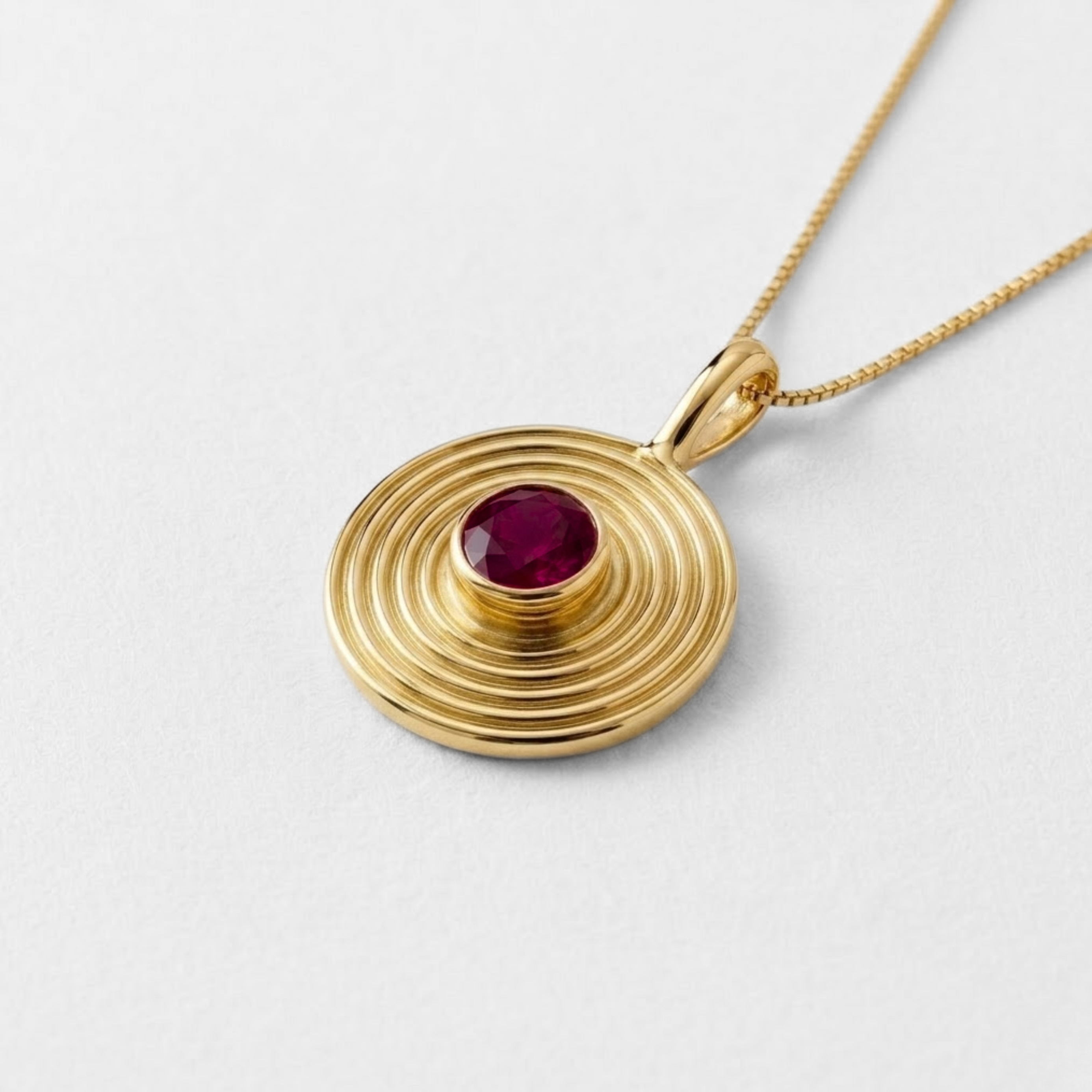 18k gold vermeil bezel pendant with round natural ruby on delicate chain — July birthstone representing nobility and purity.