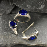 Created sapphire solitaire earrings in sterling silver, perfect gift for September birthdays, embodying elegance and timeless beauty.