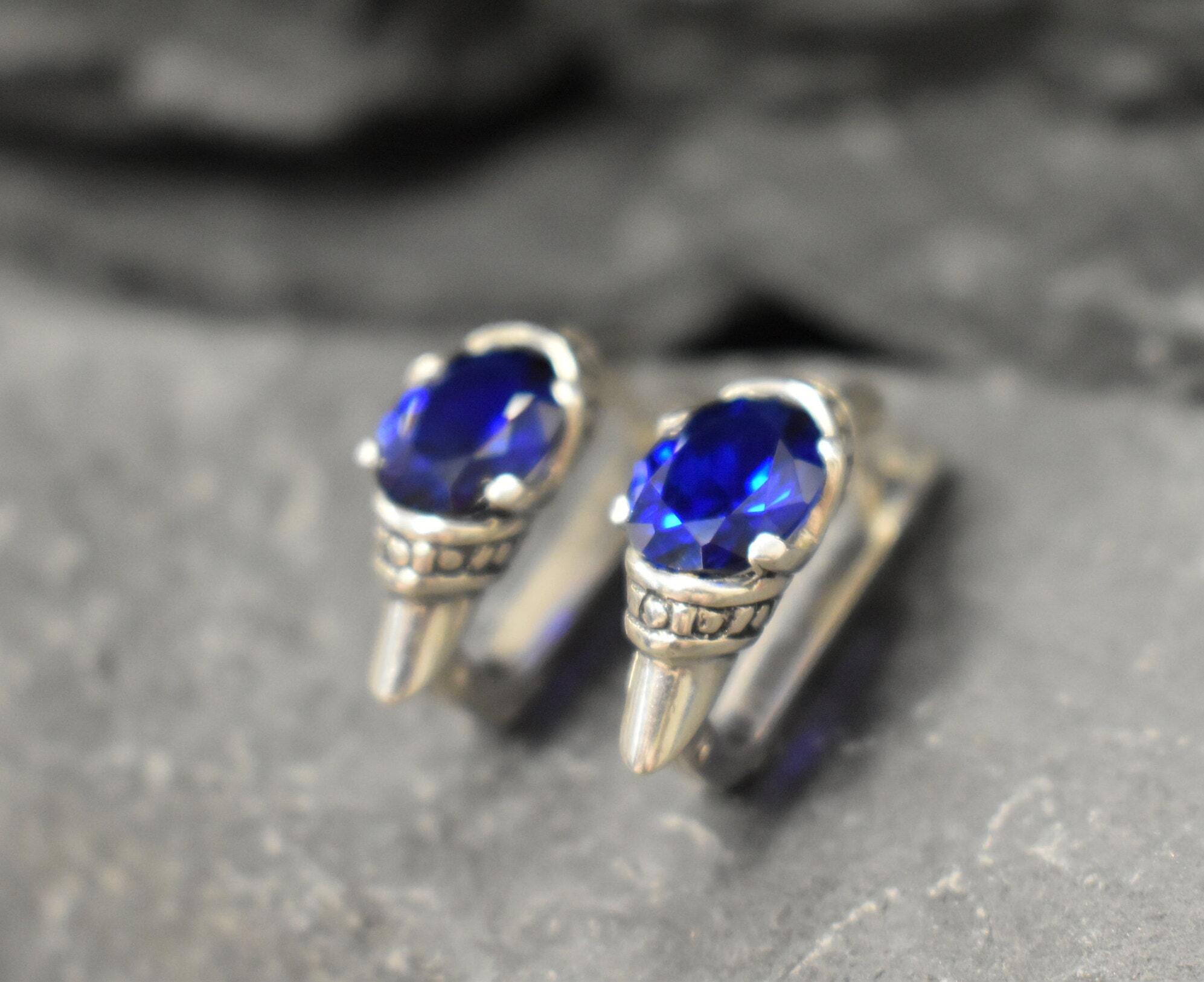 Created Sapphire Earrings made in 925 Sterling Silver with Oval Created Blue Sapphire in Solitaire setting, September Birthstone gift idea, symbolizes sincerity, truth, and faithfulness, ideal for everyday wear and perfect for birthday gifting and special occasions.