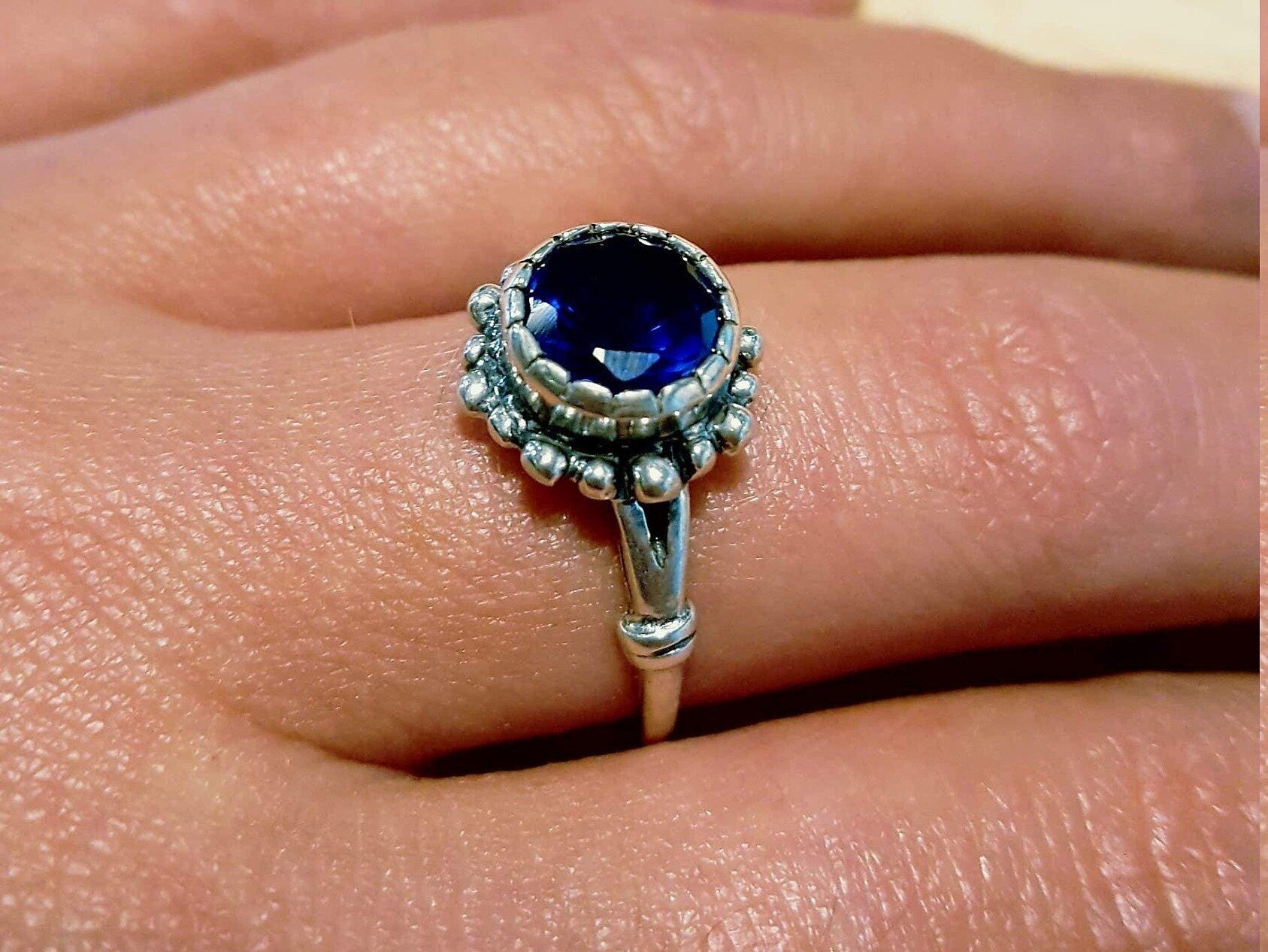 925 Sterling Silver Sapphire Ring featuring a round blue sapphire, perfect for September birthdays and meaningful gifts.