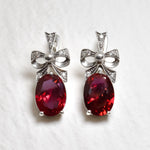 Created Ruby Earrings made in 925 Sterling Silver with Oval Created Red Ruby in Solitaire with Accents setting, July Birthstone gift idea, symbolizes nobility, purity, and passion, ideal for everyday wear and perfect for birthday gifting and special occasions.