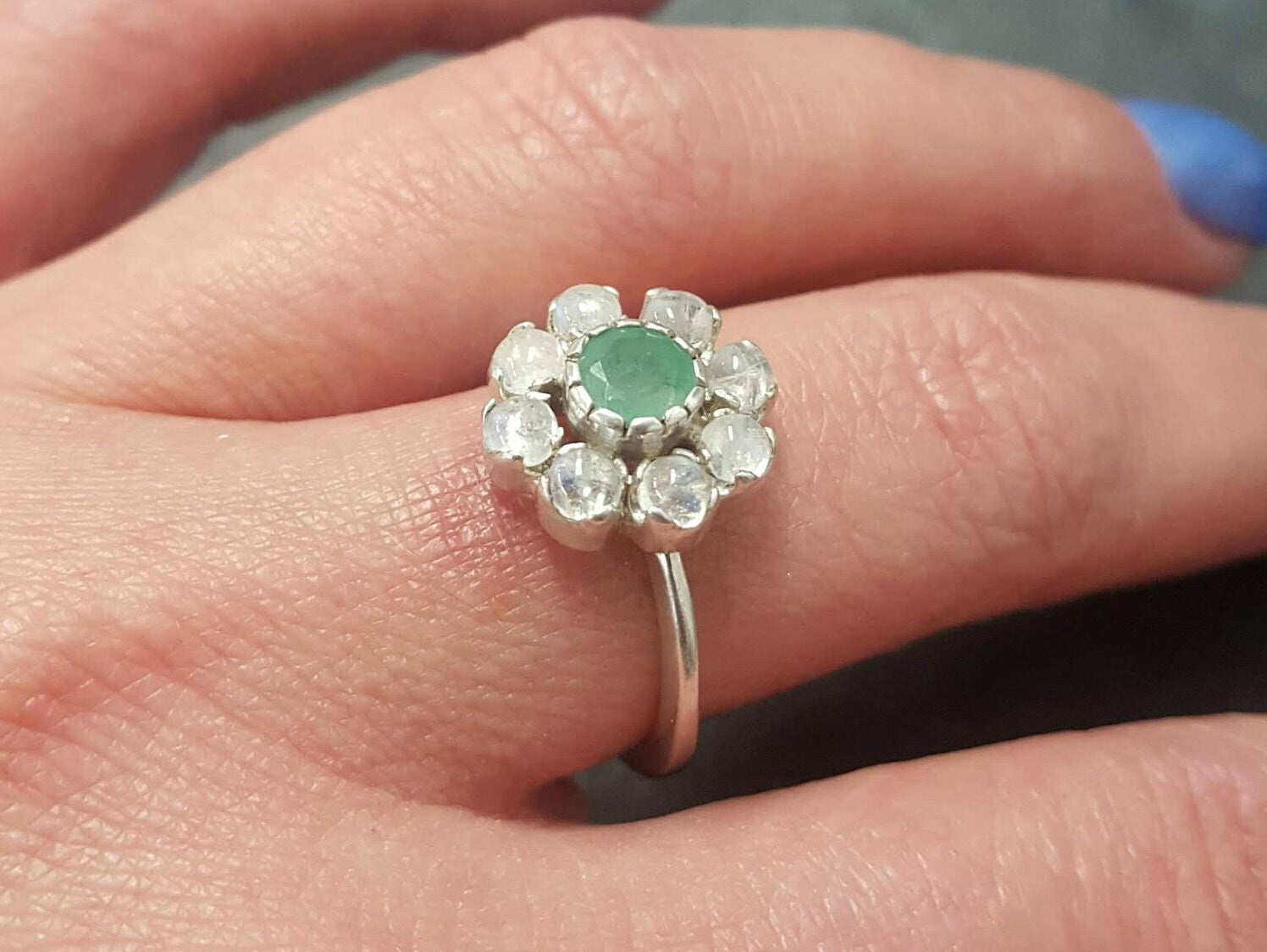 Elegant 925 Sterling Silver ring featuring a cluster of natural green emeralds, symbolizing growth and harmony, perfect for special occasions.