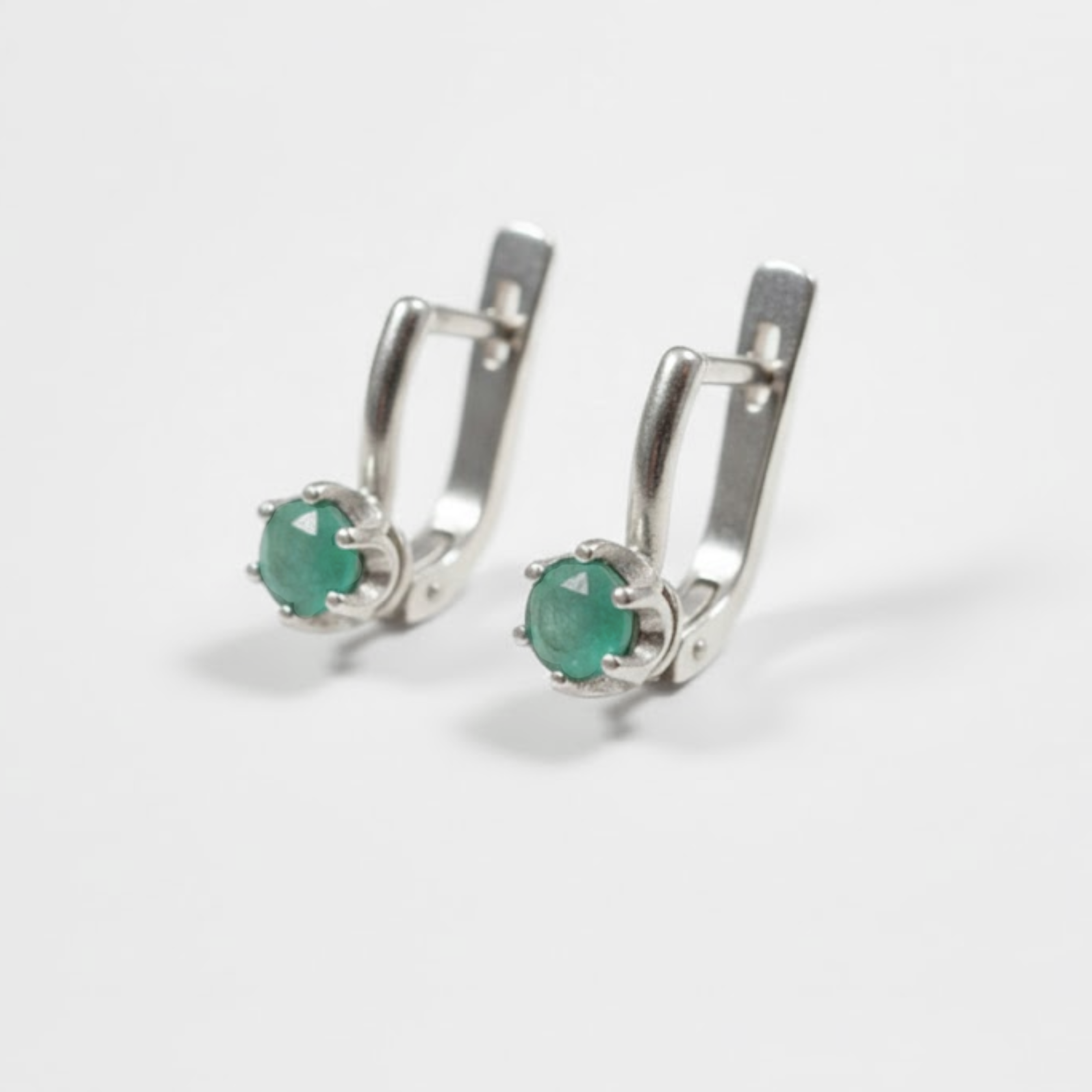 Stylish round natural emerald earrings in 925 sterling silver, symbolizing harmony—great for special occasions and daily use.