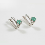 Chic sterling silver earrings with natural emeralds, celebrating May's birthstone—perfect for enhancing any outfit and special moments.