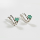 Chic sterling silver earrings with natural emeralds, celebrating May's birthstone—perfect for enhancing any outfit and special moments.