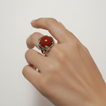 A close-up of a sparkling Adina Stone ring set against a soft velvet background, showcasing its intricate design and details.